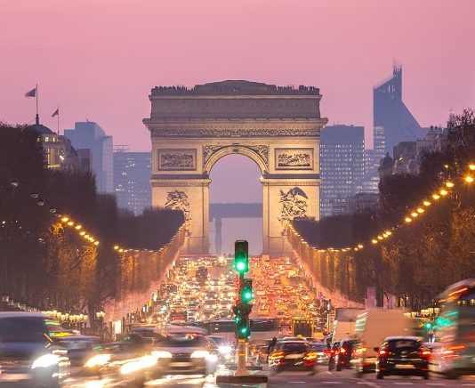 Paris Arc of Triomphe along Champs-Elysees France sunset