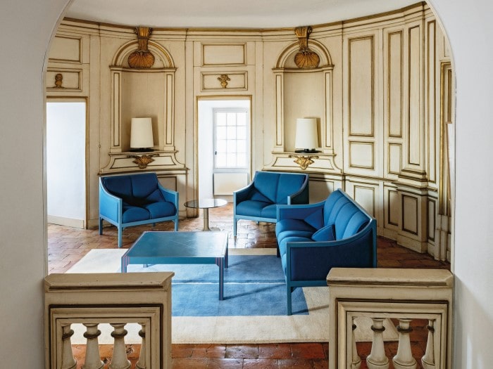  the blue furniture in the living room was originally designed by Pierre Paulin for the Élysée office of President Mitterand